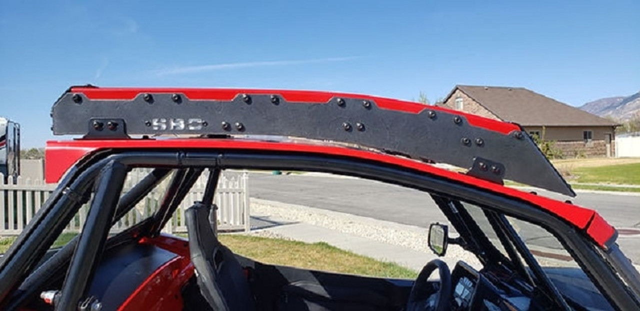 An Arctic Cat Prowler roof rack, installed on a UTV parked in a driveway