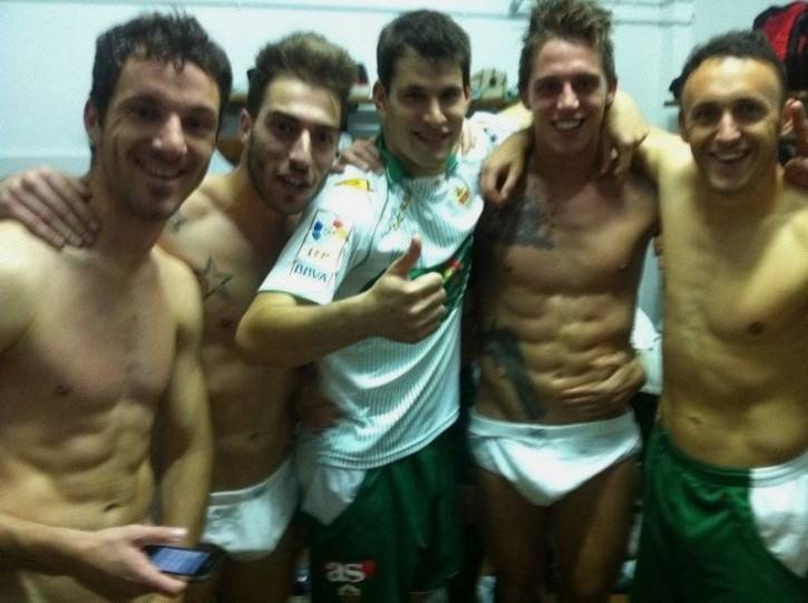 gay male locker room fantasy with shirtless and half naked males smiling for the camera in the mens change room for their football league