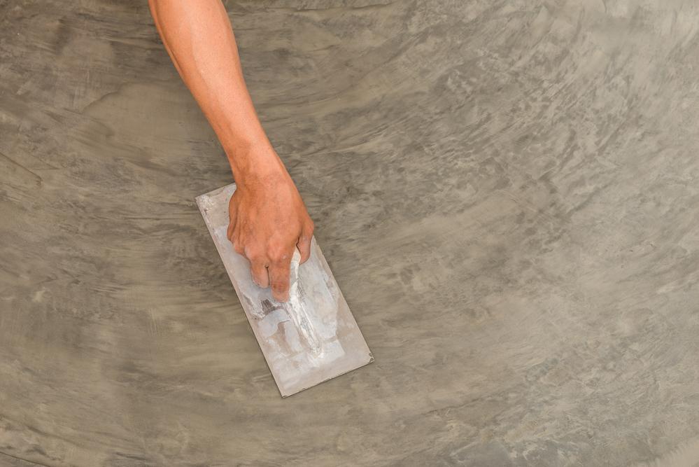 professional hands finishing the concrete floor

