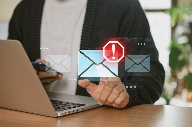 Photo a businessman using a laptop at home is receiving email warning alerts about spam viruses and hackers as well as network security concept