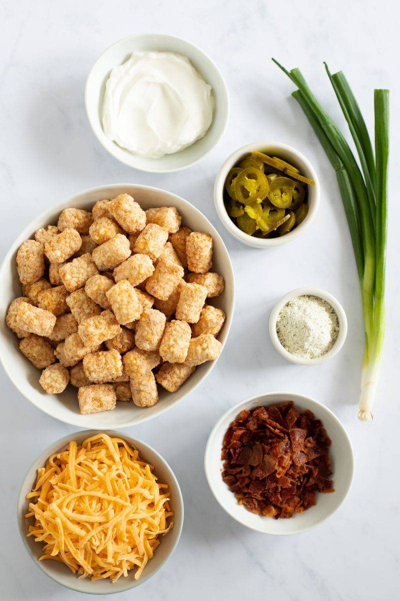 Loaded tater tots ingredients on a counter.