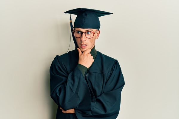 Young grad in cap, questioning 'Why Does a Degree Matter for Working Adults?