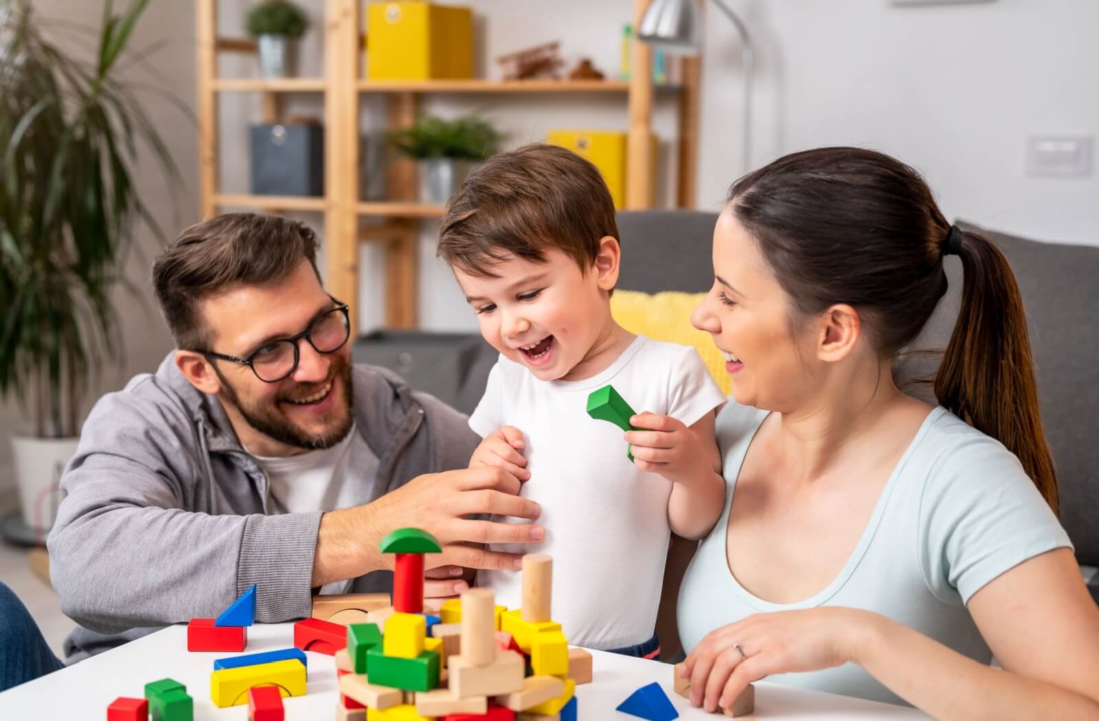 Young parents playing with their child.