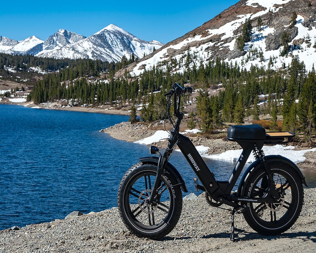 black and white mountain bike on gray sand near body of water during daytime