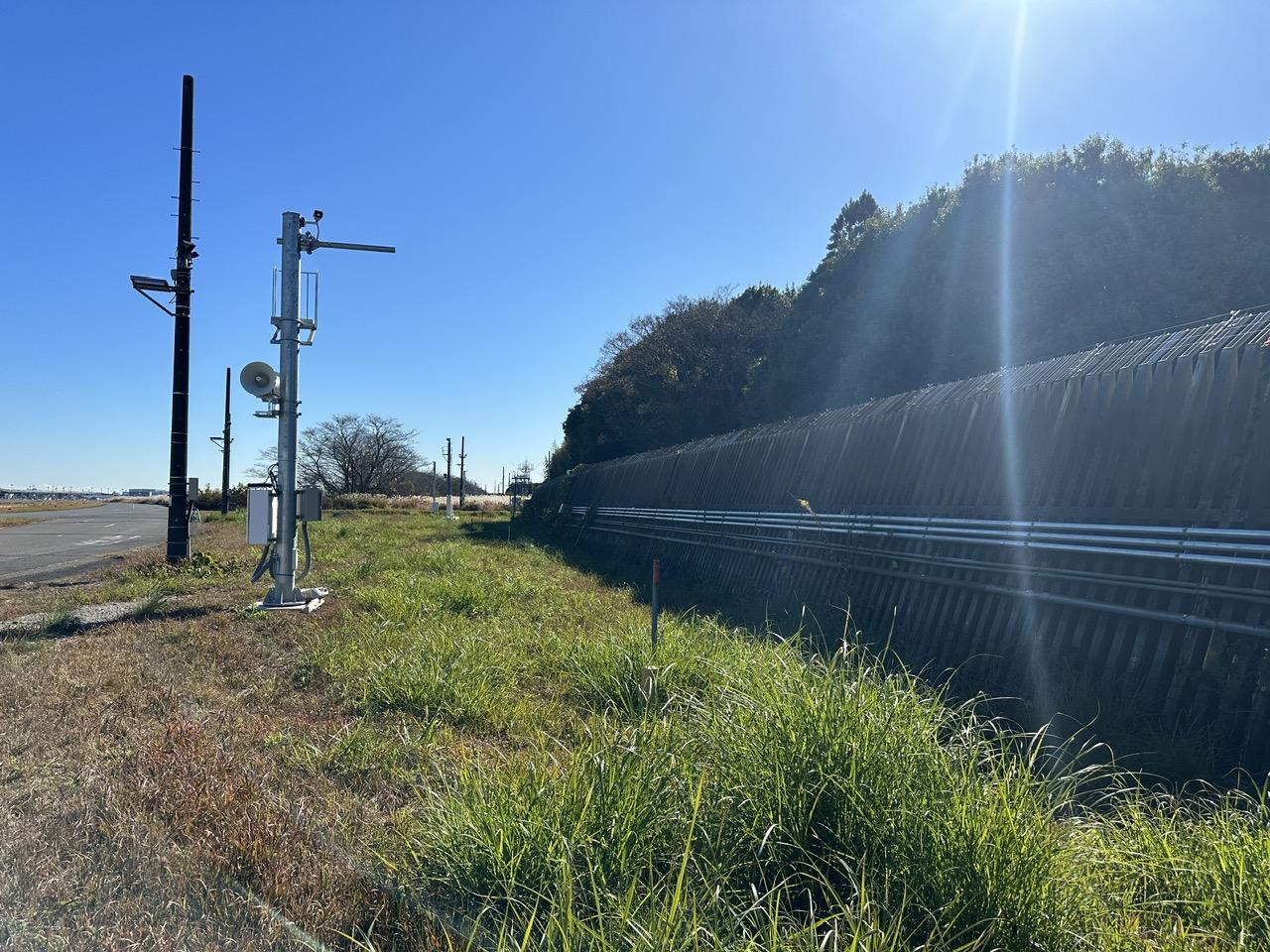 A train tracks next to a fenceDescription automatically generated