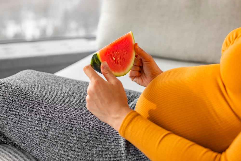 pregnant women eating watermelon