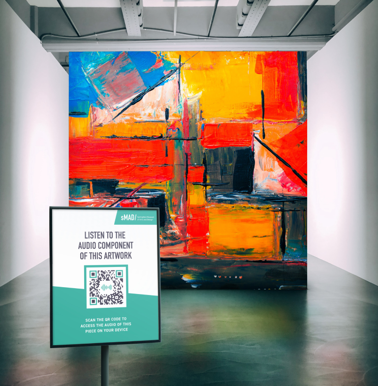 An audio QR Code sign in front of a colorful piece of art in a museum.