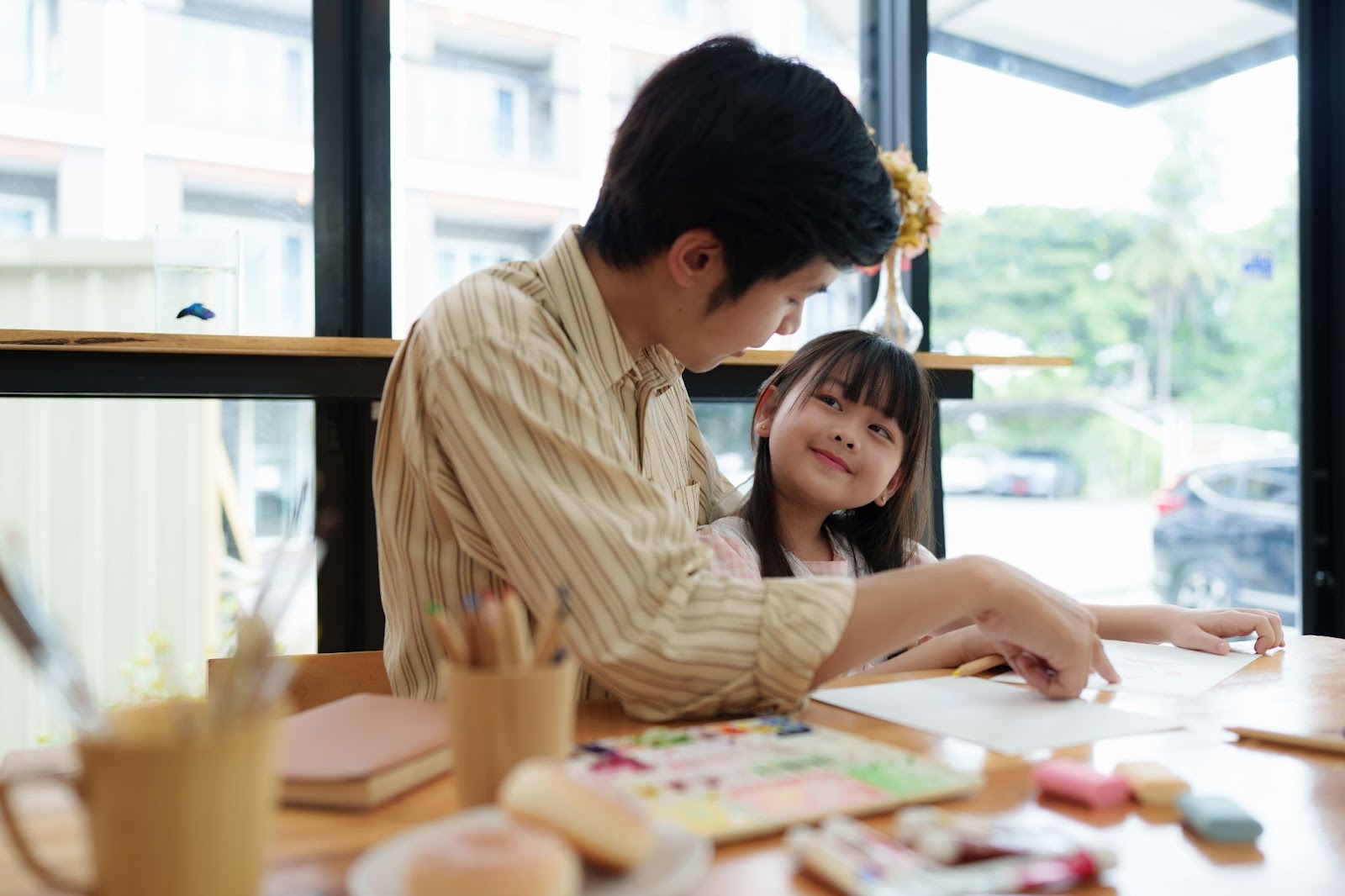 Parent helping child with reading and learning for academic readiness