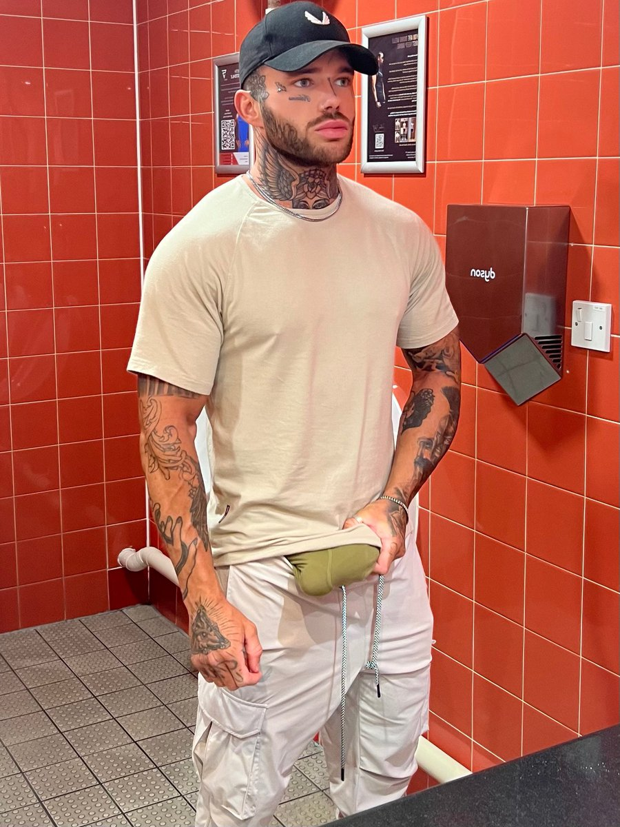  Joel Hart with his hard erect dick pulled out of his shorts in the gym bathroom posing for a selfie