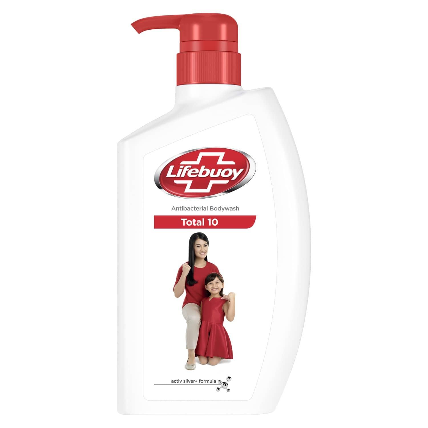 A white bottle with a red lid

Description automatically generated