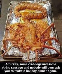 Caption: A turkey, some crab legs, and some string sausage and noboby will ever ask you to make a holiday dinner again.

Picture of an alien looking creature having been splayed and cooked on a tinfoil lined pan.