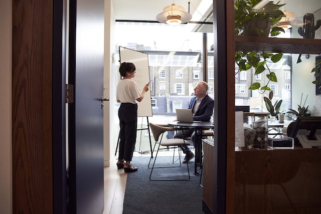 A person standing next to a person and discussing something