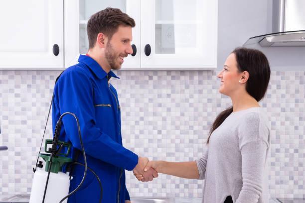 Pest Control Worker Shaking Hands With Woman Male Pest Control Worker Shaking Hands With Happy Woman In Kitchen Pest Control stock pictures, royalty-free photos & images