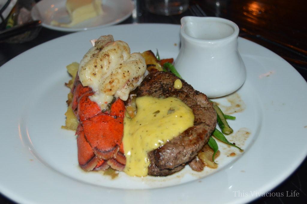 Lobster and steak on a white plate