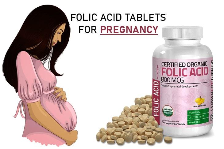 A pregnant person with a bottle of vitamins

Description automatically generated