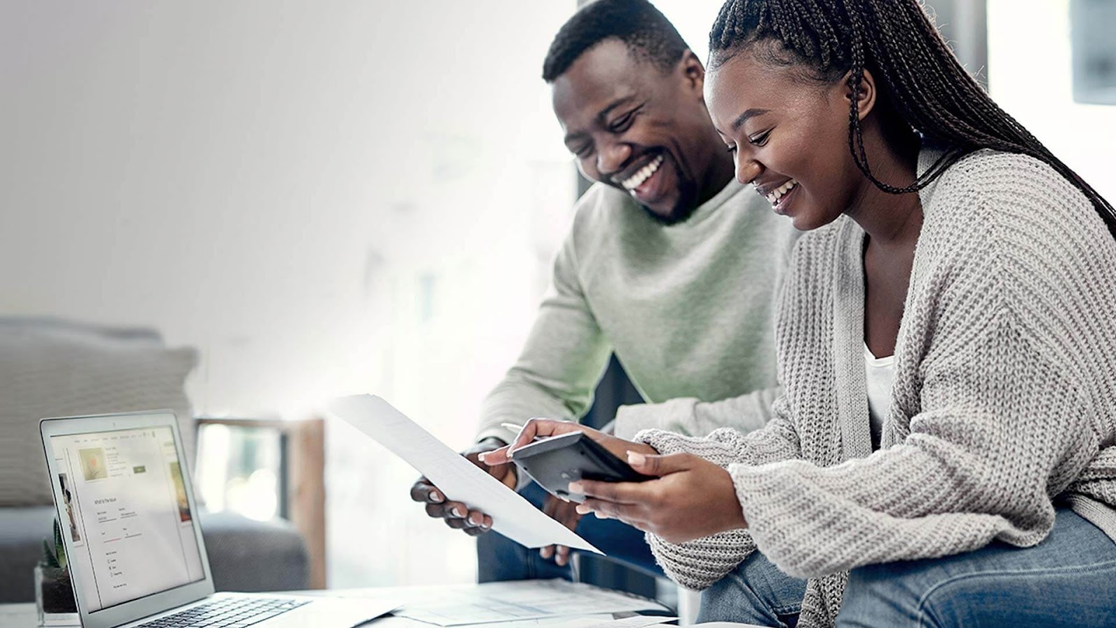 couple reading document smiling