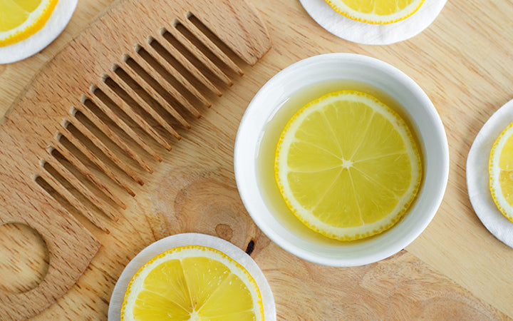 lemon juice lemon slices and ingredients for preparing homemade hair mask, hair dye or face toner.