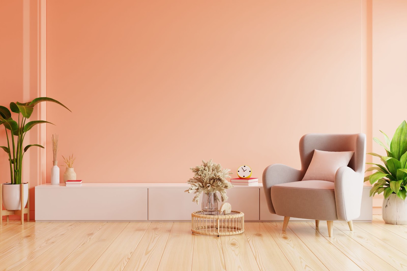 Image of a minimalist living space with low white shelf, single wingback chair, and a wall painted in the color peach fuzz