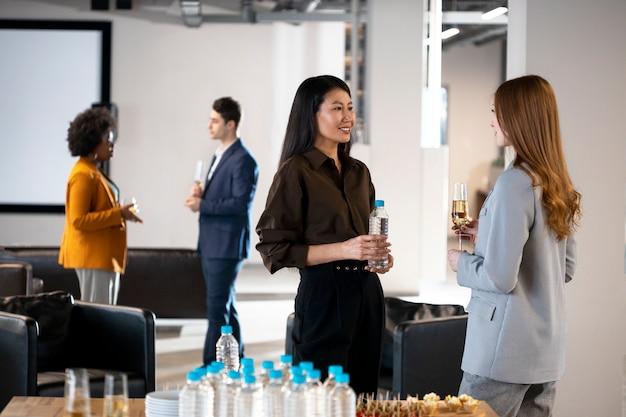 Close up smiley women chatting at company event