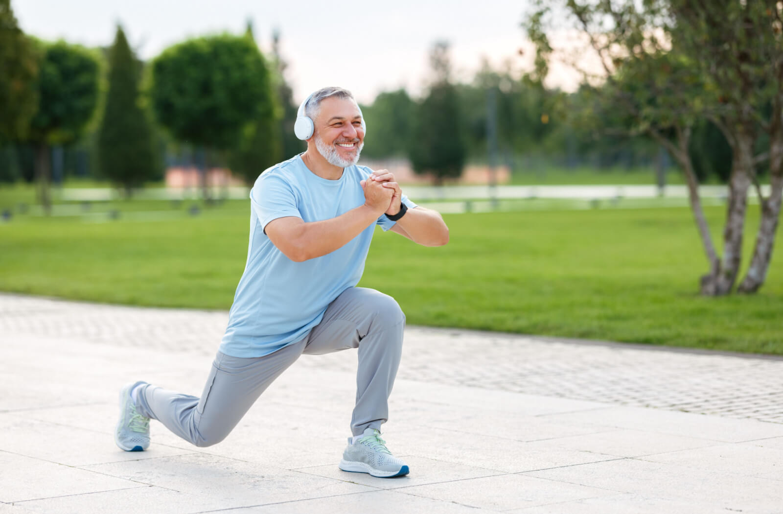 An older adult man exercising outdoors.