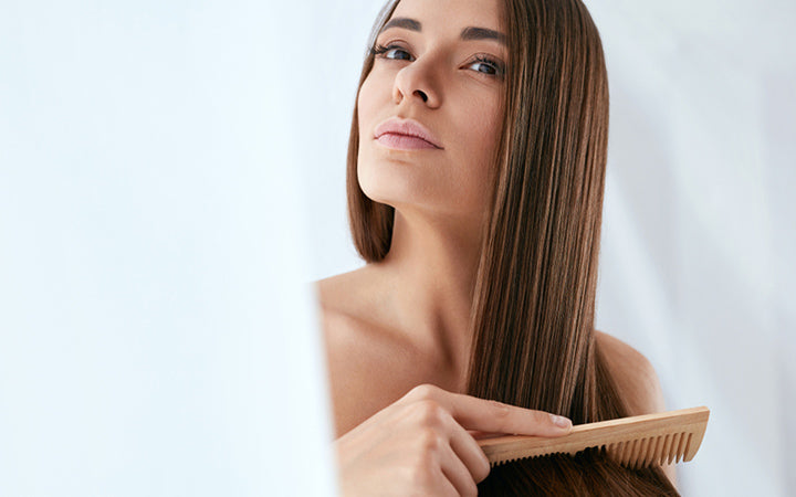 beautiful woman combing long natural hair