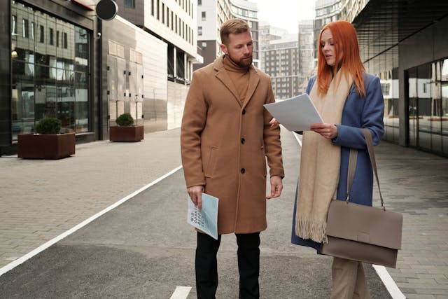 Two people standing in the middle of a busy city street