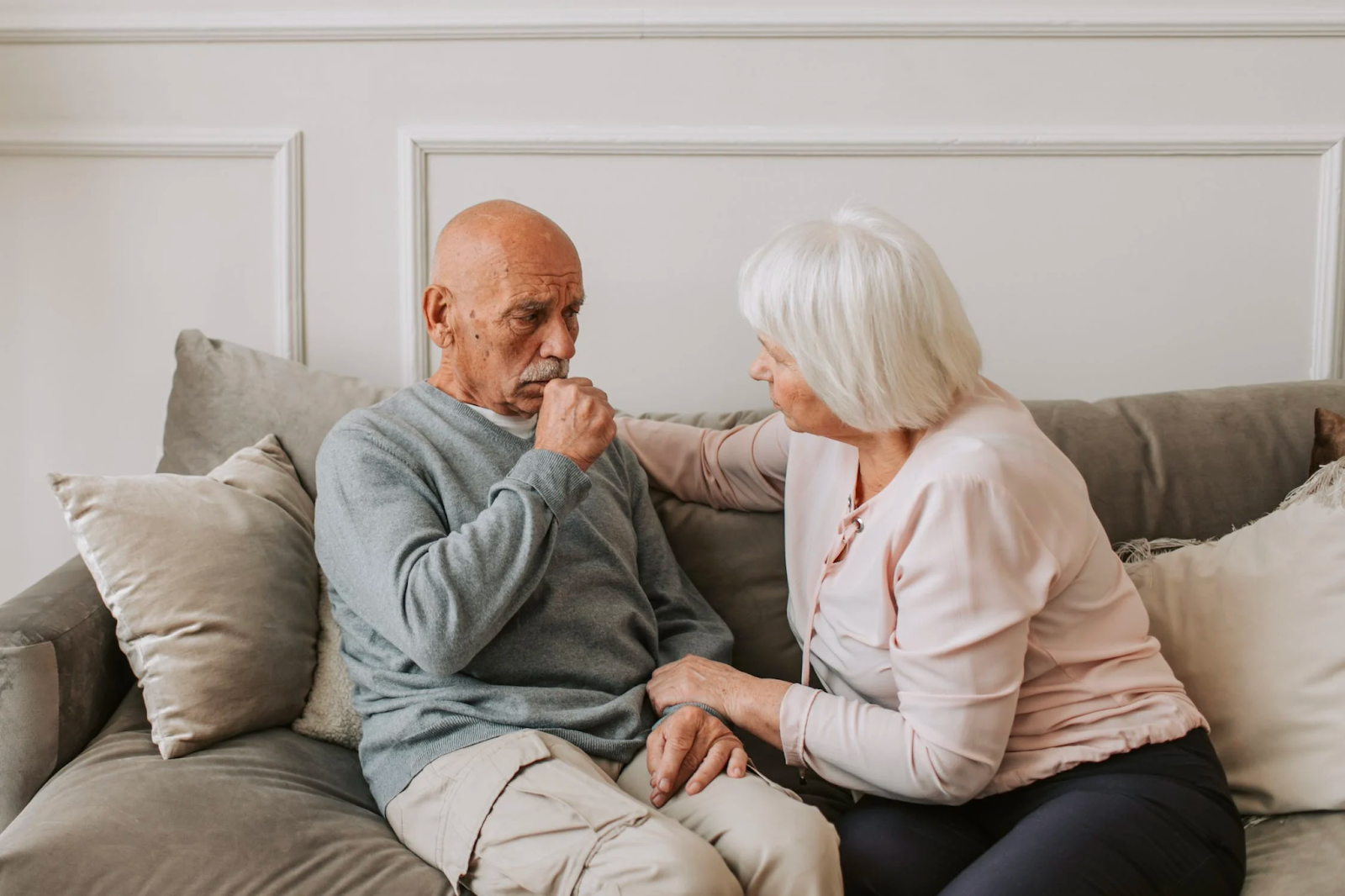 an elderly couple sitting on a couch