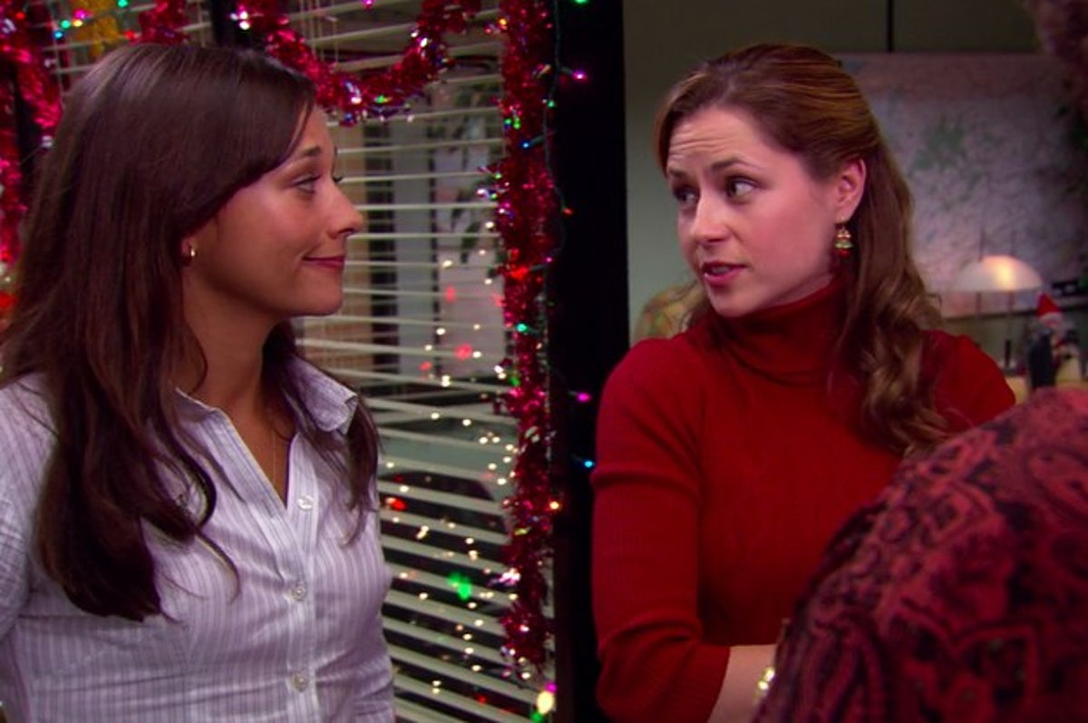 Pam with her arms crossed looking over to Karen in front of Michael's office. Pam is saying something to Karen and Karen looks to be nodding up in agreement. One of the best holiday tv episodes.