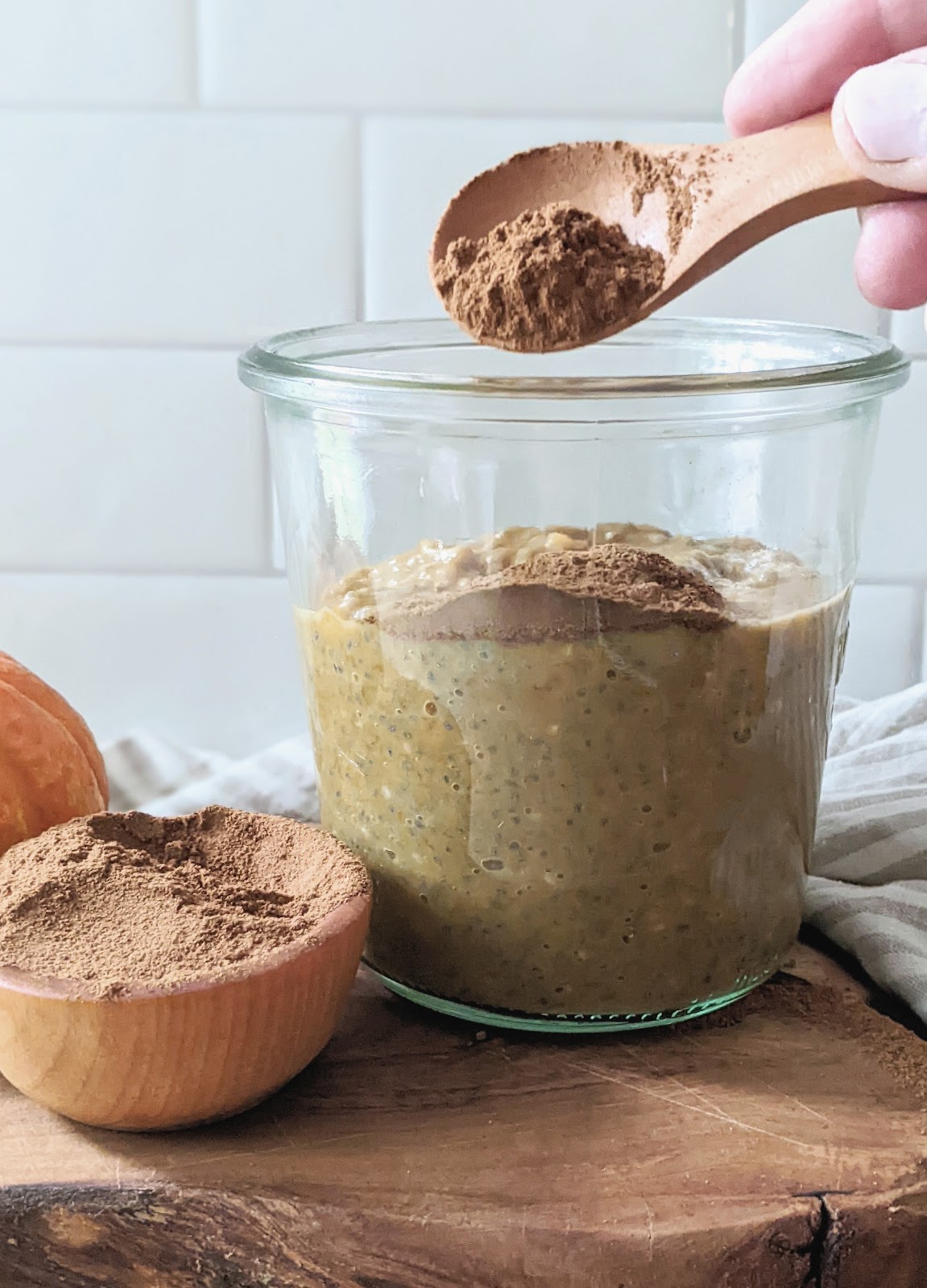 close up of pumpkin spice added to a glass jar