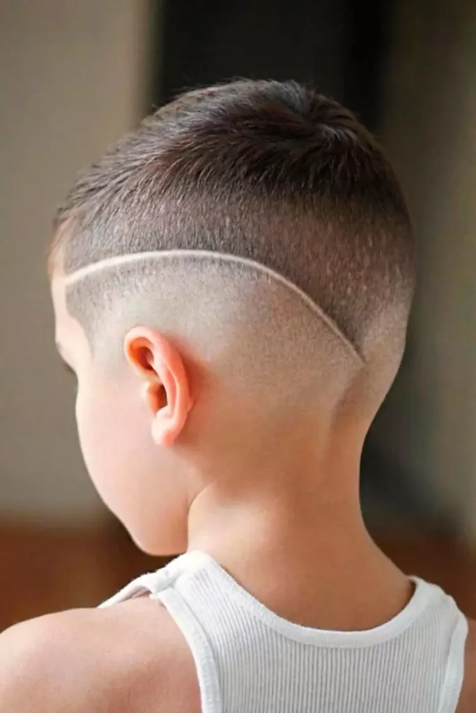 Back view of a  boy rocking the buzz cut with shaved line