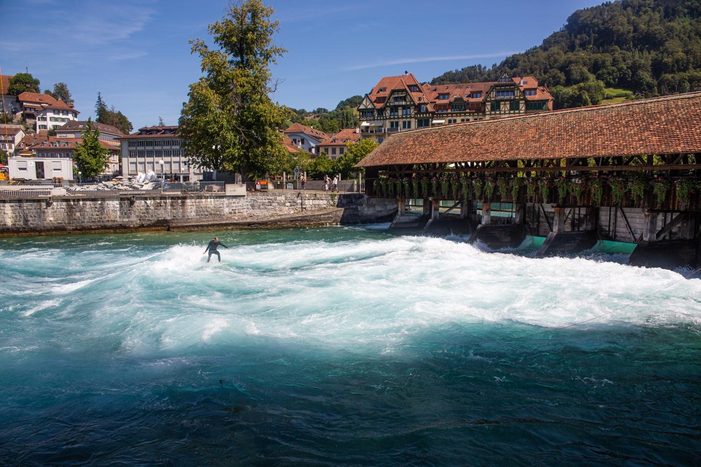 A person surfing on a river

Description automatically generated