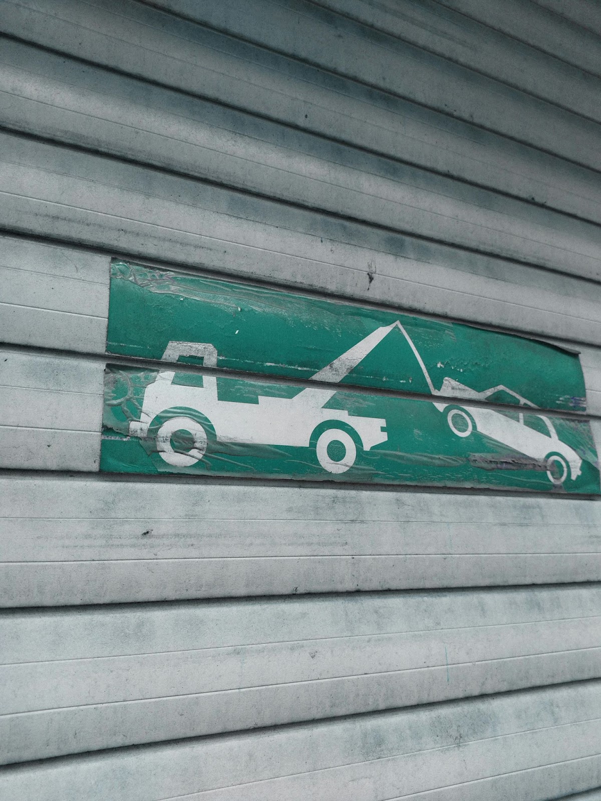 A stenciled picture of a tow truck towing a vehicle