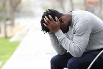 Sad depressed black man on a bench in a park | The Daily The Daily