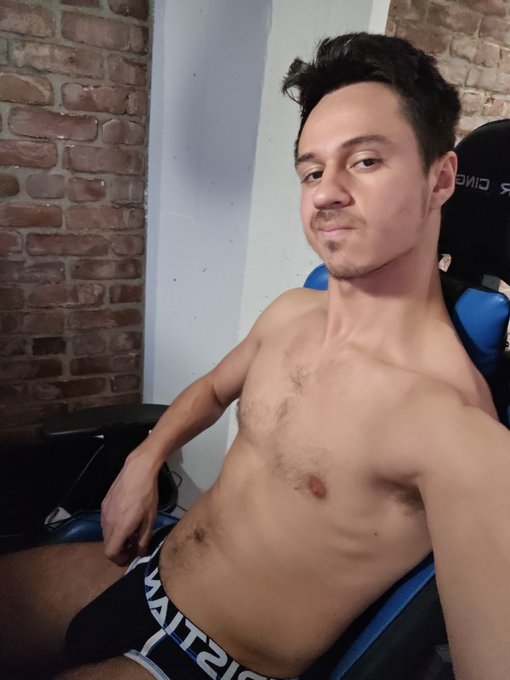 Dakota Wonders wearing black gay underwear and shirtless in his blue gaming chair