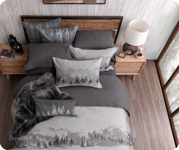 Our Plateau Duvet Cover shown on a bed from a top down angle with wooden furniture.