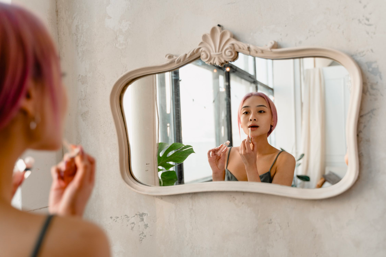 A young woman looking at herself in the mirror