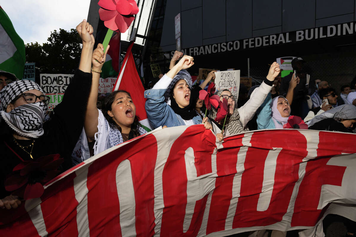 Marchers hold a banner outside the federal building in San Francisco during a rally in solidarity with Palestinians. The protest was one of many across the country and around the world as part of International Day of Solidarity.