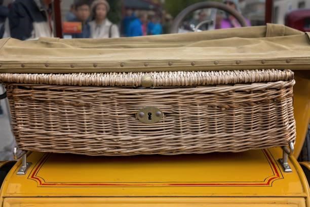 Wicker Carry Basket On A Vintage Car A wicker picnic basket on the boot of a vintage car Roof basket for your road trip stock pictures, royalty-free photos & images