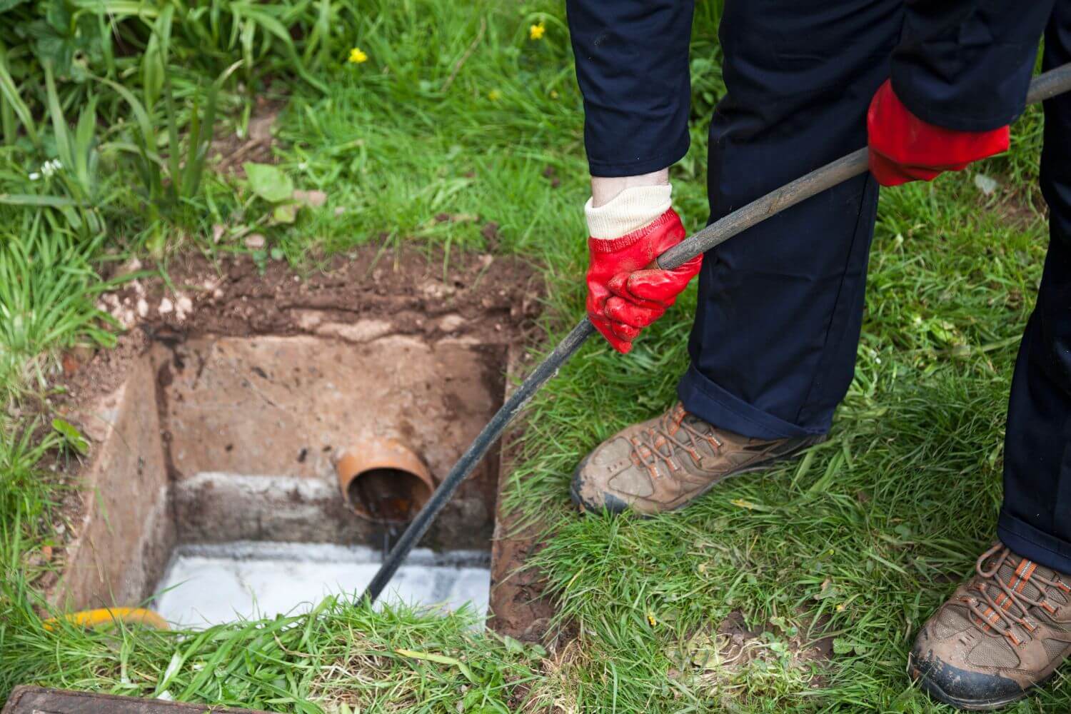 Homeowner unclogging sewer lines at a home