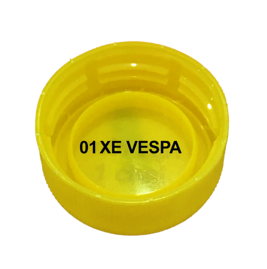 A yellow plastic bottle cap