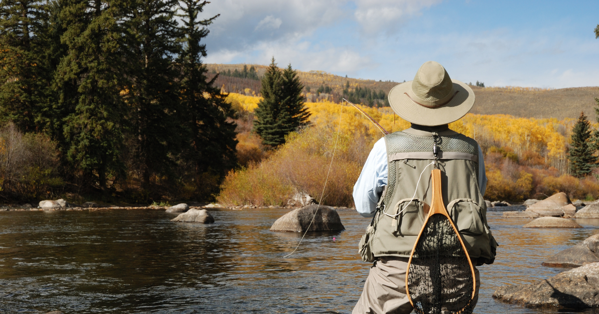 Fly fishing in scenic Roaring Fork River amidst fall color