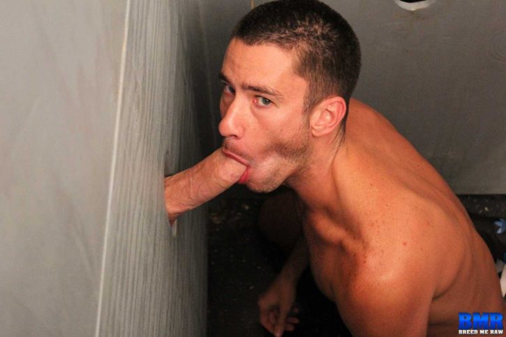 gay male sucking large fat thick gay cock through glory hole wall on his knees