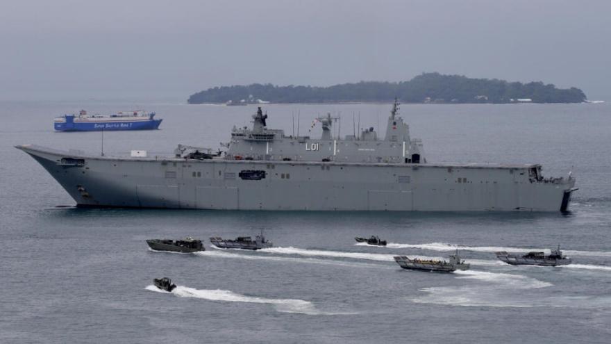 FILE - In this Oct. 15, 2017 file photo, the Royal Australian Navy HMAS Adelaide cruises alongside landing crafts with Philippine Marines and Australian troops as they conduct a joint Humanitarian Aid