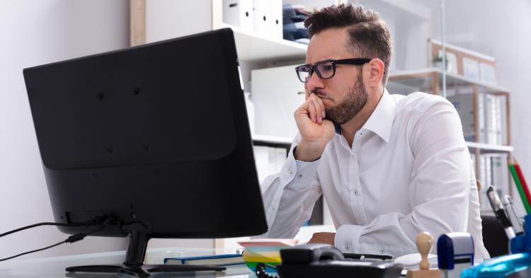 man looking at computer screen