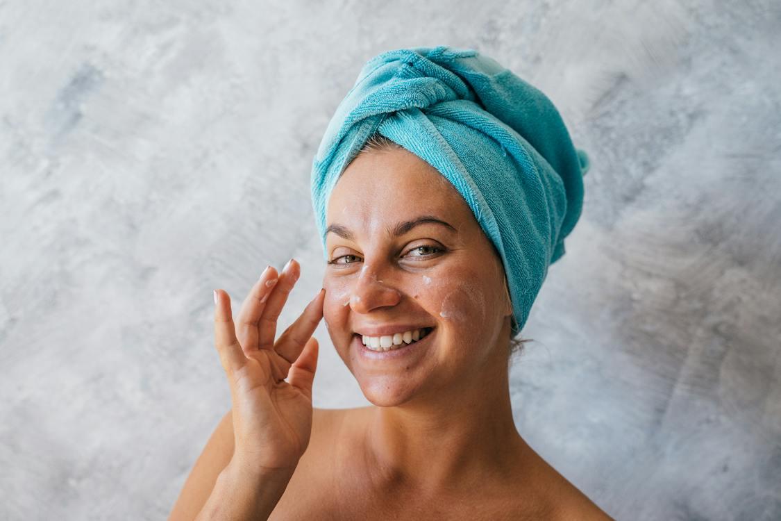 Free A Smiling Woman with a Towel Wrapped in Her Head Stock Photo