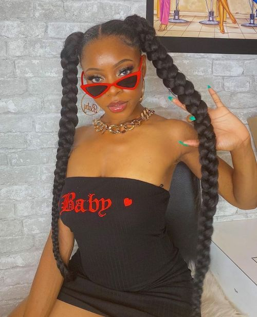 Picture of lady on shades showing off her 90s modern day look