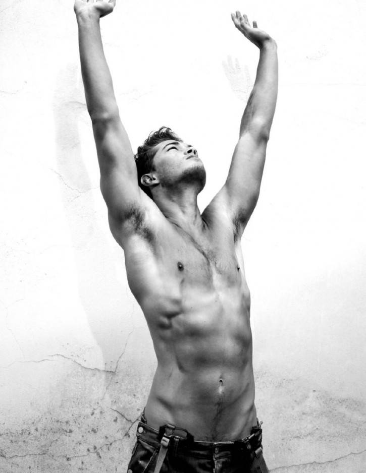 francisco lachowski shirtless with his hands in the air showing off his greased up gay twink torso