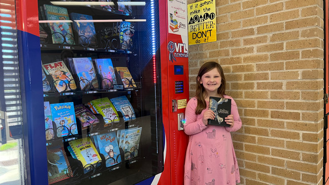 First Grader at Inchy's Bookworm Vending Machine. (photo by WCTI News 12 Reporter Bilyana Garland)