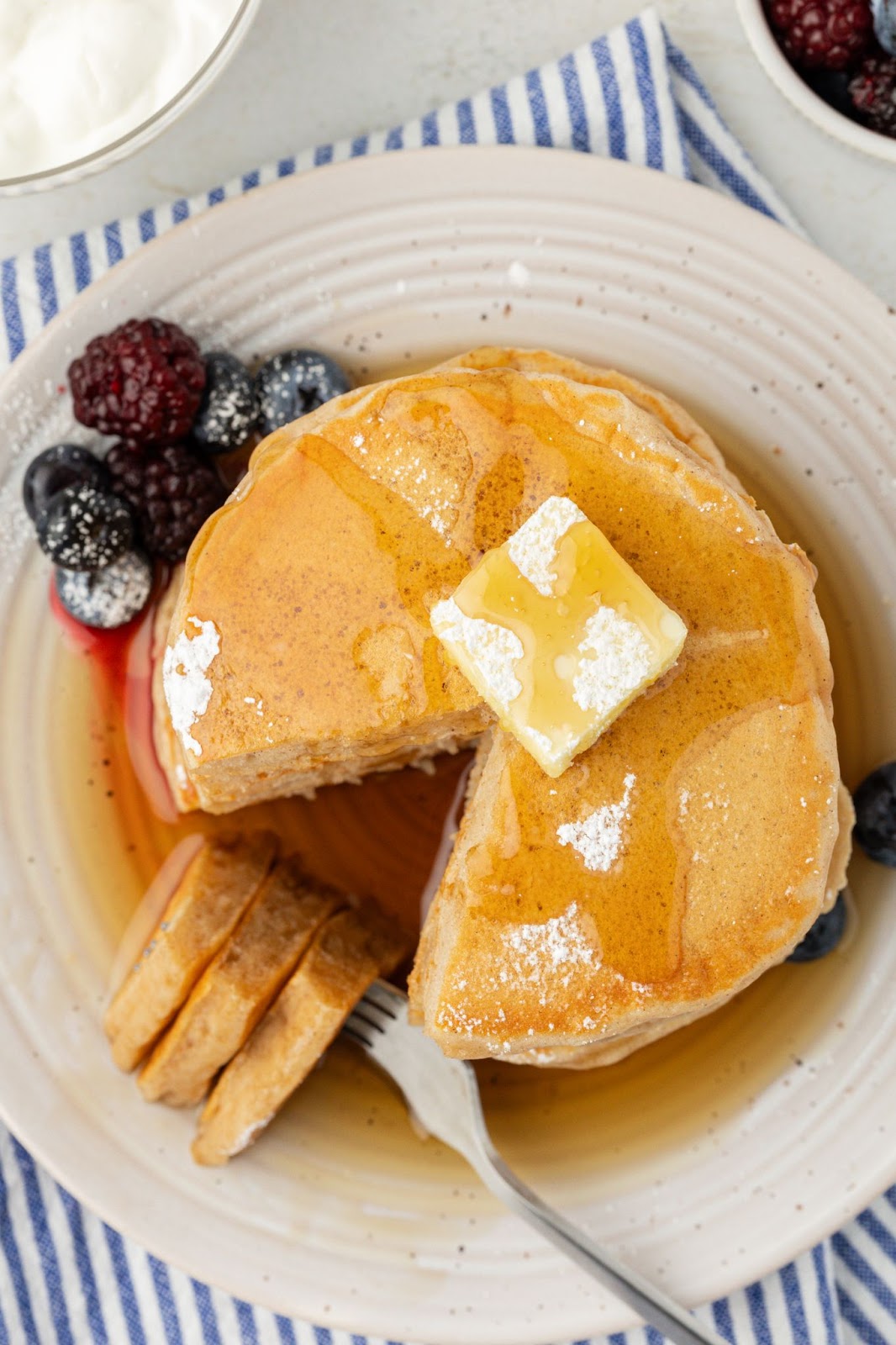 top down view of a plate of greek yogurt pancakes topped with butter and syrup