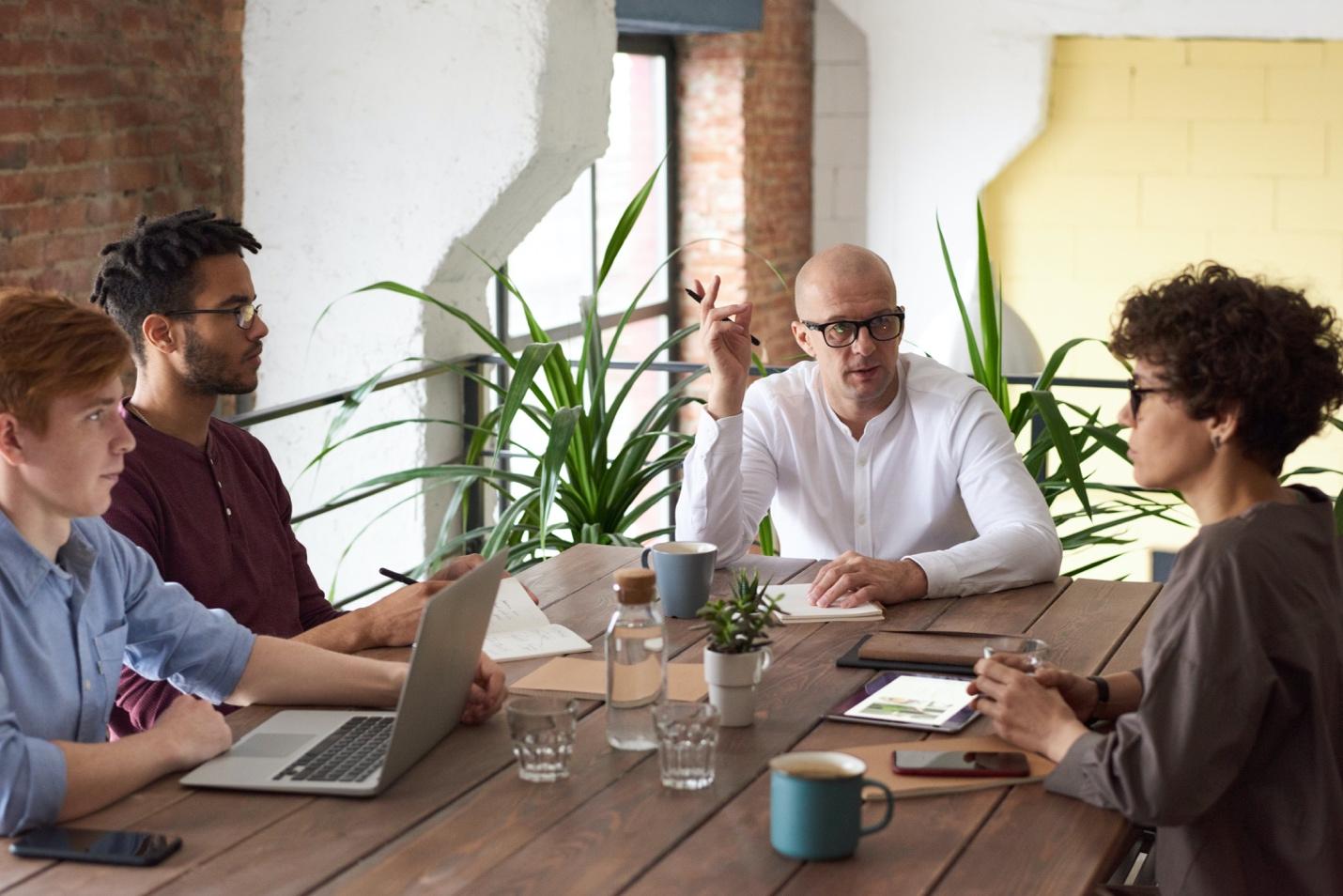 A group of people sitting around a table

Description automatically generated